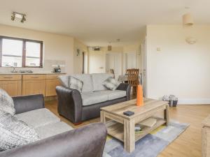 a living room with a couch and a table at Shoreline in Marazion