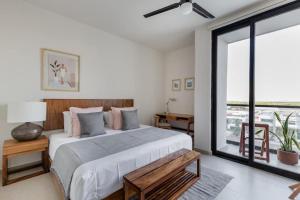 a bedroom with a large bed and a large window at San Francisco by Andiani Travel in Cancún