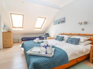 a bedroom with a bed with a tray on it at Tides in Padstow