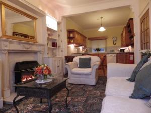a living room with two chairs and a fireplace at The Central Guesthouse in Kelso