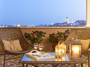 a table with wine glasses and a candle on a balcony at Be Mate Casa Di Bava in Istanbul