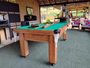 a pool table with a green top in a room at Rancho Zé Valentim in São José dos Campos