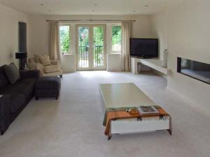 a living room with a couch and a coffee table at Clouds Hill in Almondbury
