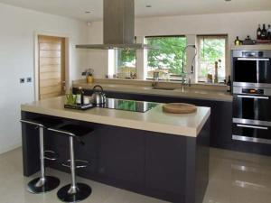 a kitchen with a large island with a counter top at Clouds Hill in Almondbury