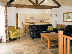 a living room with a couch and chairs and a table at Nant yr Hendre in Llanfair-Dyffryn-Clwyd
