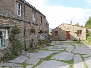 a stone house with a stone walkway in front of it at Wagon House in Horton in Ribblesdale