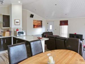 a kitchen and living room with a table and chairs at High View Lodge in Windermere +9 photos