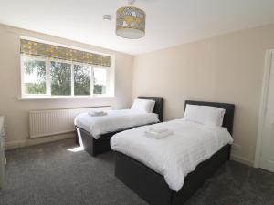 A bed or beds in a room at Strelley Court Farm