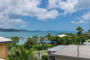 a view of the ocean from a house at Airlie Sunset Waterview Apartment in Airlie Beach