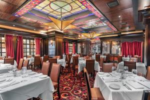 ein Restaurant mit weißen Tischen und Stühlen und einem Kronleuchter in der Unterkunft Golden Nugget Hotel & Casino Las Vegas in Las Vegas