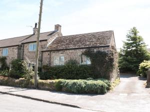 a brick house with a pole in front of it at Cobbled Corner in Elton