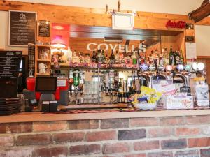 a bar with a lot of bottles of alcohol at Bishop Cottage in Loftus +8 photos