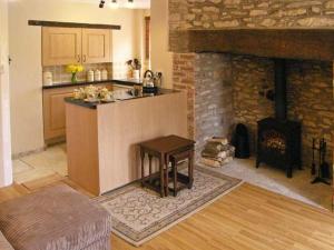 a kitchen with a counter and a stove in a room at Candy Cottage in Bradford Abbas