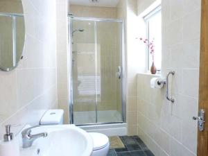 a bathroom with a shower and a sink and a toilet at White Gables in Great Clifton +15 photos