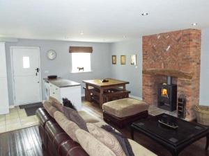 a living room with a couch and a fireplace at Alveton in Alton