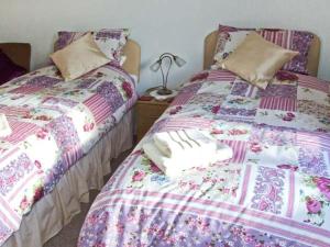 two beds sitting next to each other in a bedroom at Loningside in Wombourn