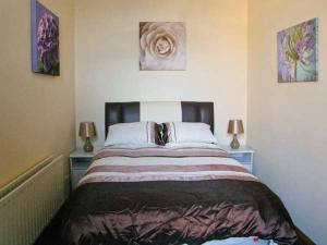 a bedroom with a large bed with two night stands at The Reiver's Retreat in Haltwhistle