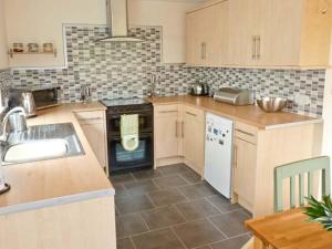 a kitchen with a sink and a stove top oven at 15 Forest Park Lodges in High Bickington