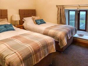 sypialnia z 2 łóżkami i oknem w obiekcie Orcaber Cottage w mieście Austwick