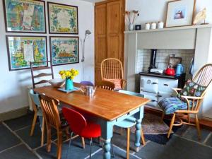 a dining room with a wooden table and chairs at Raceside Farm in Silecroft