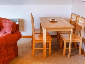 a dining room table and chairs and a table and a couch at Suil Na Mara in Aultbea