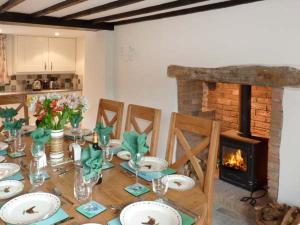 a dining room table with a fireplace in a kitchen at Greenslades in Exford