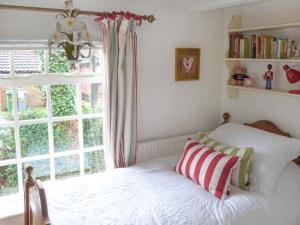 a bedroom with a bed in front of a window at Ted's Place in Aylsham