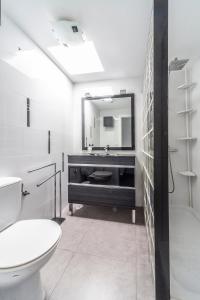 a bathroom with a sink and a toilet and a mirror at Luxury Apartment Gueldera in Playa Honda