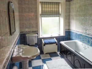 a bathroom with a tub and a toilet and a sink at Cottage in the Sky in Luddenden Foot