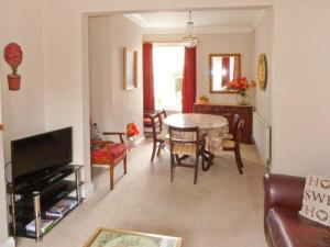 a living room with a table and a dining room at Elizabeth House in Hornsea