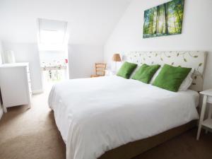 A bed or beds in a room at The Stables, Crayke Lodge