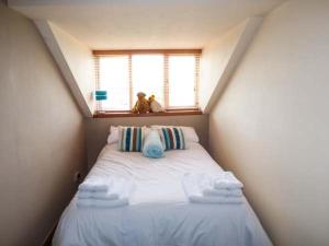Cama pequeña en habitación con ventana en Off Puddle Hill, en Stowe