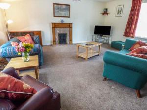 a living room with two couches and a tv at Moorside in Horrabridge