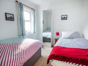 a bedroom with two twin beds and a window at Pen Hill in Llantwit Major