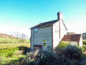 a small house in the middle of a field at Pensychnant Cottage in Conwy +1 photo