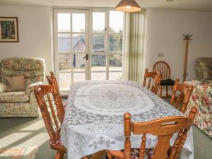 a dining room with a table and chairs at West Bowden Farm in Knowstone