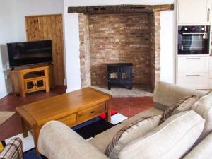 a living room with two couches and a fireplace at Cotswold View in Shottery