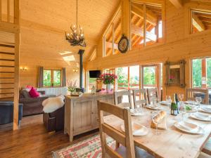 a dining room and living room with a table and chairs at Hampton Lodge in Penley