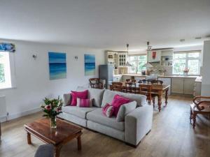 a living room with a couch and a dining room at 4 The Nab House in Bembridge