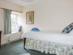 a bedroom with a large bed and a window at Townhead Farmhouse in Patterdale