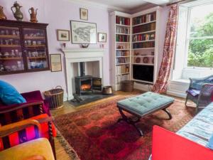 a living room with a fireplace and a couch and a table at Flanders Hall in West Burton