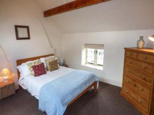 OnecoteにあるGorsthead Mill Farmのベッドルーム1室(ドレッサー付きのベッド1台、窓付)
