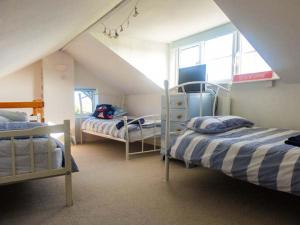 a room with two bunk beds in a attic at Y Lleiaf in Holyhead