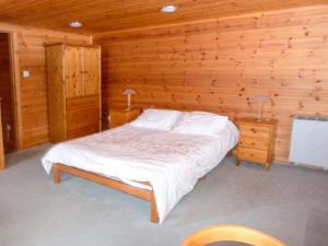 a bedroom with a bed in a log cabin at Strathavon Chalet in Aviemore