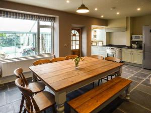 a large kitchen with a wooden table and chairs at Parkgate in Windermere