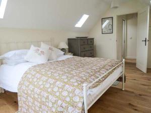 a bedroom with a bed and a dresser at Ham's House in Coreley