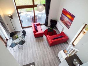 an overhead view of a living room with red furniture at Budmouth in Broadwey