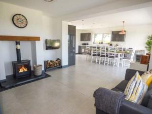 a living room with a couch and a fireplace at Caeau Mawr in Henllan