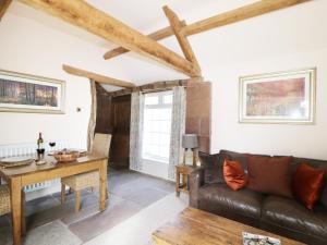 a living room with a couch and a table at Faraway Cottage in Kirklinton