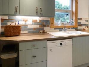 a kitchen with a sink and a counter top at Coorie Doon in Nairn